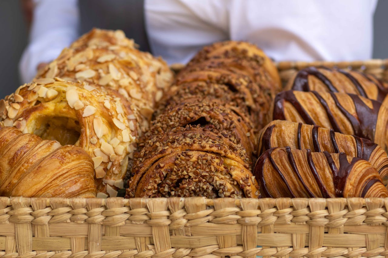 Close-up view of a basket filled with assorted French pastries, perfect for bakery lovers.